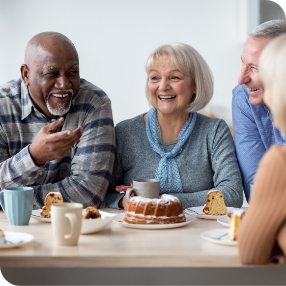 elderly group talking over pound cake