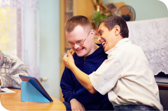 disabled man using iPad with healthcare worker