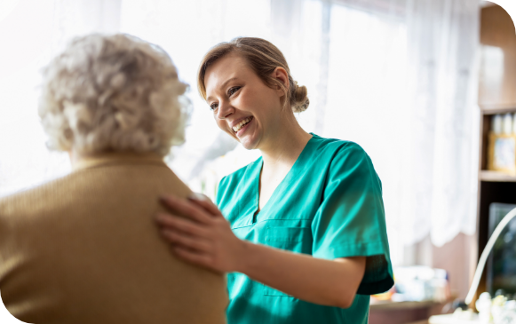 elderly woman embraced by healthcare worker